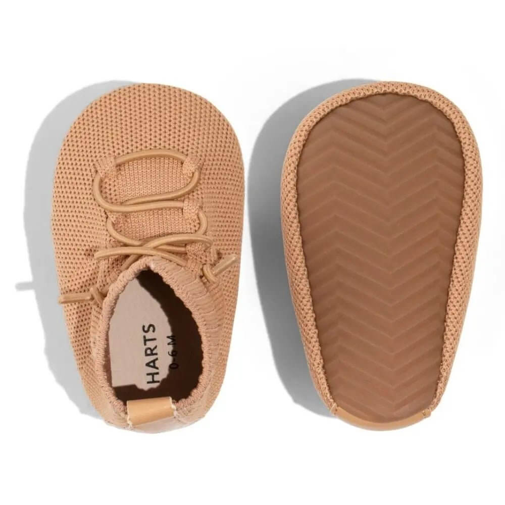Cozy baby booties and toddler booties, ideal newborn shoes for comfortable first steps. Close up of grippy soles and shoes for learning to walk. bootees or booties boots for toddlers and babies