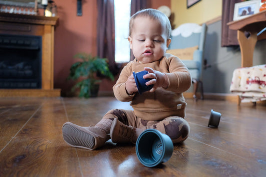I8 month boots for toddlers and baby holding plastic toy