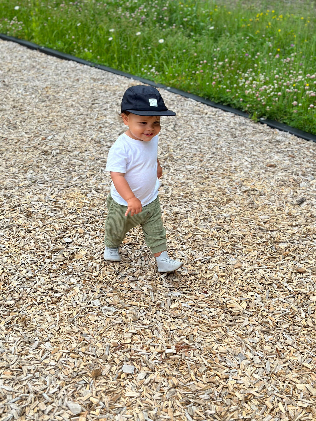 toddler taking first steps in lightweight HARTS shoes