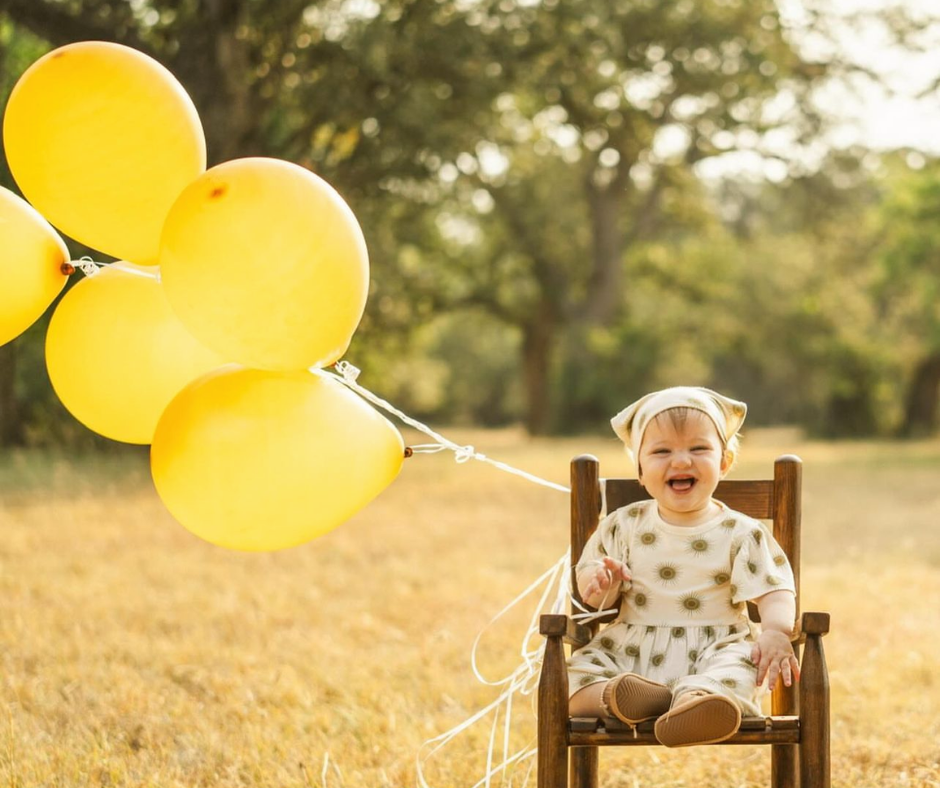 A happy baby wearing soft, flexible HARTS Bootees.